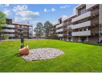 Well-manicured lawn area with surrounding apartment buildings and landscaping at 384 S Ironton St # 413, Aurora, CO 80012