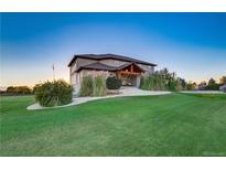 Charming home with lush green lawn, decorative rocks, and well-kept landscaping at 17635 Silver Fox Ct, Mead, CO 80542