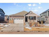 Ranch-style home with a neutral exterior, stone accents, and a two-car garage at 39 N Waterloo St, Aurora, CO 80018