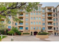 Beautiful exterior view of a multi-story building with a fountain and lush landscaping at 2500 E Cherry Creek South Dr # 306, Denver, CO 80209