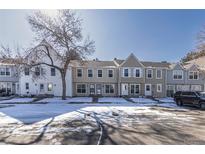Charming townhomes in a row on a street with a large tree, offering curb appeal and a sense of community at 8858 W Dartmouth Pl, Lakewood, CO 80227