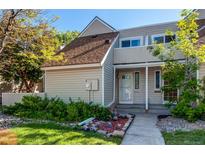 Charming home with light beige siding, a brown roof, and well-maintained landscaping at 2479 S Xanadu Way # C, Aurora, CO 80014