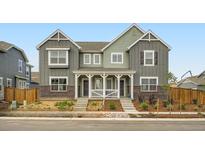 Charming duplex with a cozy front porch and well-maintained landscaping at 15277 Fillmore St, Thornton, CO 80602