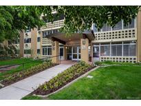 Inviting building entrance with well-maintained landscaping and visible address signage at 9300 E Center Ave # 2B, Denver, CO 80247
