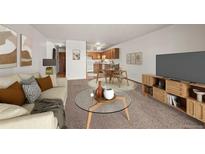 Open-concept living room showcases a dining area and a seamless flow into the kitchen space at 9300 E Center Ave # 2B, Denver, CO 80247