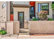 Charming multi-level home featuring brick accents and an inviting front entrance with minimalist landscaping at 1932 W 32Nd Ave, Denver, CO 80211