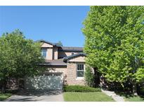 Charming two-story home featuring stone accents and a well-manicured front yard and an attached garage at 2601 Pemberly Ave, Highlands Ranch, CO 80126