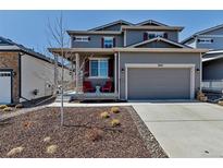Charming two-story home with a well-manicured front yard and inviting front porch, perfect for relaxing outdoors at 3953 John Ave, Castle Rock, CO 80104