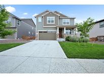 Charming two-story home with a well-manicured lawn, covered porch, and two car garage at 652 Pinecliff Dr, Erie, CO 80516