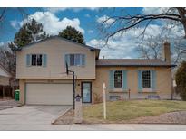 Charming two-story home with a combination of siding and brick, complemented by delightful blue shutters at 1549 S Evanston St, Aurora, CO 80012