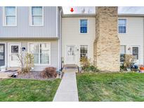 Charming townhome featuring well-maintained landscaping and a welcoming entrance at 8960 W Dartmouth Pl, Lakewood, CO 80227