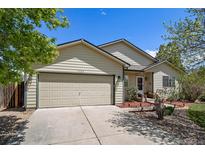 Charming one-story home with neutral siding, lush landscaping, and a two-car garage at 1933 Chestnut St, Fort Lupton, CO 80621