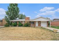 Charming single-story brick home with a well-manicured front yard and attached garage at 12063 E Arizona Dr, Aurora, CO 80012
