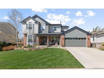 Charming two-story home with a well-manicured lawn, beautiful landscaping, and a spacious two-car garage at 7106 Cerney Cir, Castle Pines, CO 80108