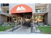 Welcoming entrance to Mountain Shadows Condominiums featuring well-maintained landscaping at 2 Adams St # 1504, Denver, CO 80206