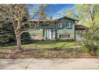 Charming home with a well-maintained lawn and mature trees, offering great curb appeal at 12829 E Oregon Dr, Aurora, CO 80012