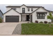 Beautiful two-story home featuring a well-manicured lawn, a two-car garage, and modern architectural design at 39405 Stockton Cir, Elizabeth, CO 80107