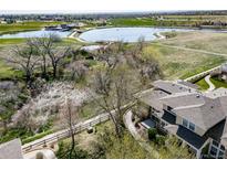 Stunning aerial view overlooking a community lake, landscaping, and the home at 3000 E 112Th Ave # 56, Northglenn, CO 80233