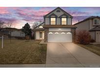 Charming two-story home with a well-manicured lawn and two-car garage, perfect for a growing Gathering at 5689 S Youngfield Way, Littleton, CO 80127