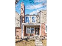 Charming townhome with a brick facade, inviting entrance and a well-maintained front yard at 4633 S Crystal Way # E189, Aurora, CO 80015