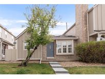 Charming townhome exterior with a well-manicured lawn and inviting entrance, showcasing lovely curb appeal at 9685 W Chatfield Ave # A, Littleton, CO 80128