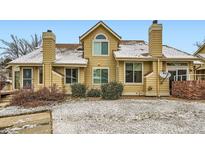 Charming exterior of a two-story townhome featuring warm siding, multiple windows, and a well-maintained front yard at 2146 S Scranton Way, Aurora, CO 80014