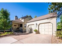 House exterior featuring a two-car garage and well-manicured landscaping at 6324 S Grape Ct, Centennial, CO 80121