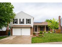 Charming two-story home featuring a brick and siding facade, two-car garage and a well-manicured front yard at 4760 S Wright Way, Morrison, CO 80465