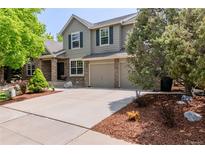 Charming two-story home with a well-manicured front yard and a spacious driveway leading to a two-car garage at 20182 E Maplewood Pl, Centennial, CO 80016
