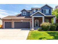 Charming two-story home featuring a three car garage, brick accents, and landscaped yard at 6694 E 129Th Ave, Thornton, CO 80602