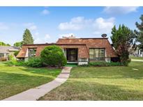Charming single-Gathering home featuring a unique roof design, green lawn, and beautiful curb appeal at 46 Douglas Dr, Broomfield, CO 80020