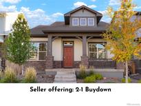 Charming two-story home with a welcoming porch and beautifully landscaped front yard at 20968 E 60Th, Aurora, CO 80019