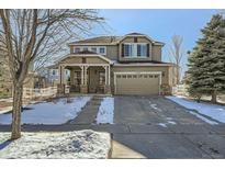 Two-story house with attached garage and snow-covered front yard at 24589 E Louisiana Cir, Aurora, CO 80018