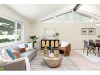 Bright living room featuring modern decor, large windows, and an open layout concept at 7453 E Jefferson Dr, Denver, CO 80237