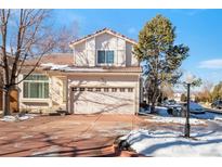 Charming two-story home with a red-tiled roof, a spacious two-car garage, and a well-maintained front yard at 1320 Laurenwood Way, Highlands Ranch, CO 80129