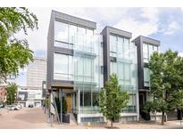 Modern townhomes boast striking architecture with large glass window panels at 1467 Delgany St # 1, Denver, CO 80202