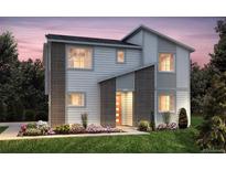 Modern two-story home featuring charming accents, lush landscaping, and a welcoming entrance at 23991 E 40Th Ave, Aurora, CO 80019