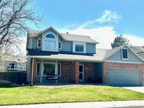 Charming two-story home with a well-maintained lawn and brick accents, perfect for a Gathering at 982 E 130Th Cir, Thornton, CO 80241