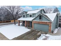 Beautiful two-story home with a well-maintained lawn and charming brick and blue siding at 982 E 130Th Cir, Thornton, CO 80241