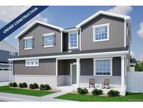 Charming two-story home with gray siding, white trim, covered porch, and attractive landscaping at 22363 E 38Th Pl, Aurora, CO 80019