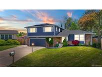 Charming two-story home with well-maintained lawn and beautiful landscaping at 6975 S Wadsworth Ct, Littleton, CO 80128