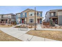 Charming townhome featuring a neat front yard with a sidewalk and inviting exteriors with varied textures and colors at 15944 E Otero Ave, Centennial, CO 80112