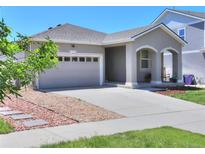 Charming single-story home featuring a well-kept front yard, and an attached two-car garage at 20194 Robins Dr, Denver, CO 80249