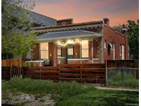 Charming brick home with a cozy front porch and a well-maintained fence at 3914 Osage St, Denver, CO 80211