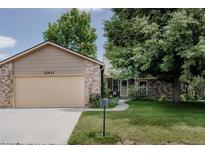 Charming single-Gathering home with a two-car garage, well-maintained lawn, and mature trees in a quiet neighborhood at 12631 W Dakota Dr, Lakewood, CO 80228