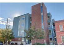 Modern brick building exterior with street view and landscaping at 2460 W 29Th Ave # 303, Denver, CO 80211