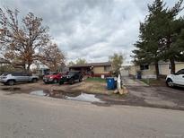 Modest single story home with brick and siding, multiple vehicles parked in the front at 5363 W 4Th Ave, Lakewood, CO 80226