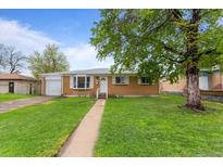 Charming single-story home with well-maintained lawn and beautiful landscaping at 690 W 1St Ave, Broomfield, CO 80020