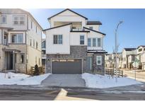Two-story modern home with gray garage and snowy front yard at 8588 Eagle River St, Littleton, CO 80125