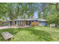 Charming single-story home featuring a well-maintained lawn and a cozy front porch area at 2220 Lee St, Lakewood, CO 80215